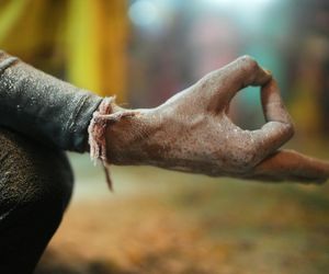 Close-up of hands in a specific yoga mudra gesture.